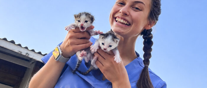 6-Nurse Ellie smiling and holding two squirming kittens Nurse Ellie smiling and holding two squirming kittens.